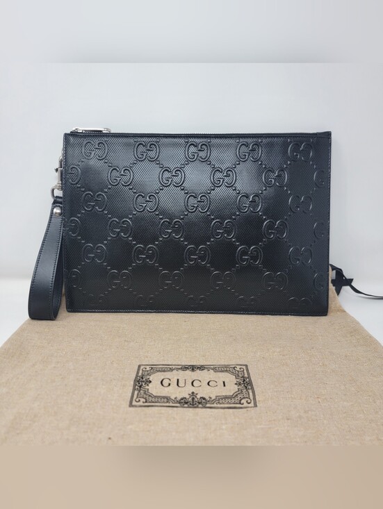 Gucci Handbags - GUCCI GG Embossed Perforated Leather Wristlet Clutch